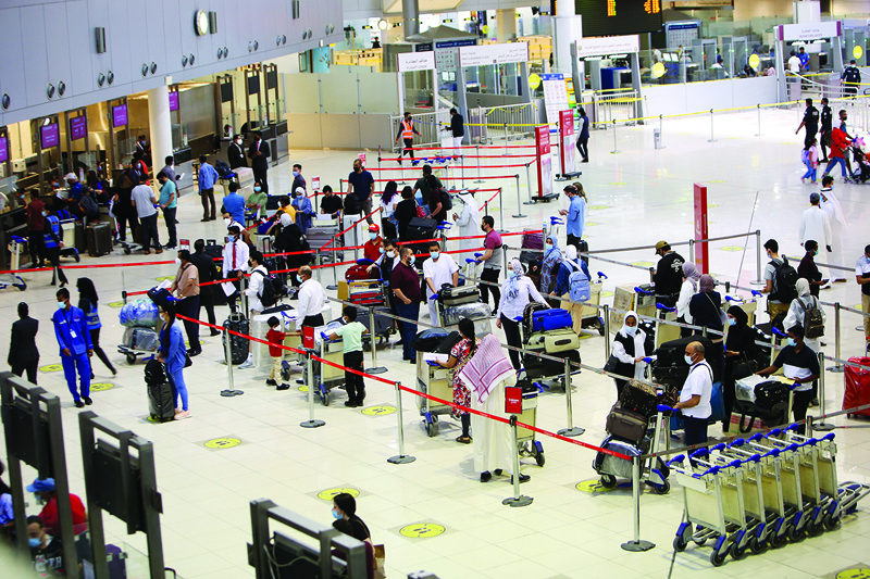 KUWAIT: Passengers queue at the check-in counters prior to their departure at Kuwait International Airport in this July 15, 2021 photo. - Photo by Yasser Al-Zayyatn