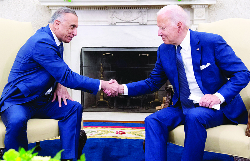 WASHINGTON: US President Joe Biden shakes hands with Iraqi Prime Minister Mustafa Al-Kadhimi in the Oval Office of the White House on Monday. - AFP n