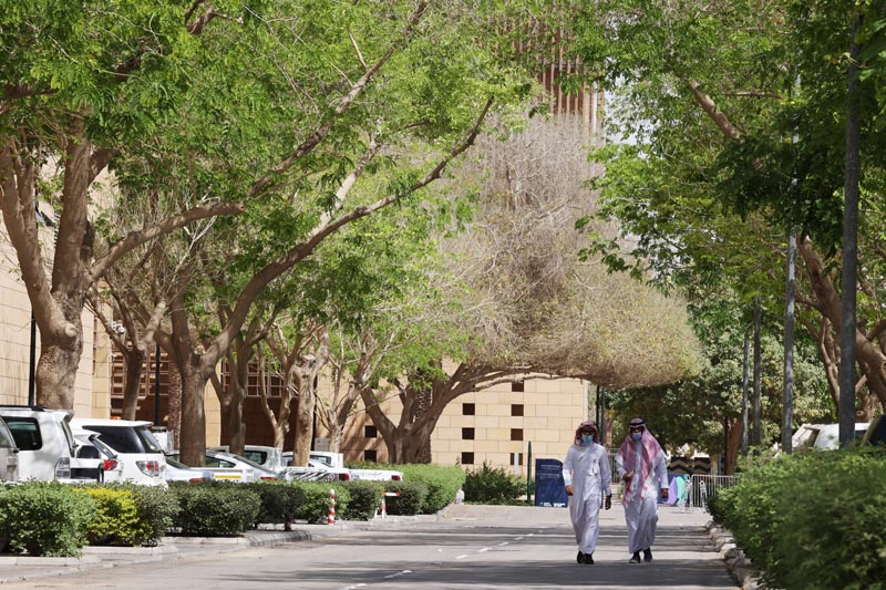 RIYADH: In this file photo taken on March 29, 2021, people walk on a tree-lined lane in the Saudi capital. – AFP n
