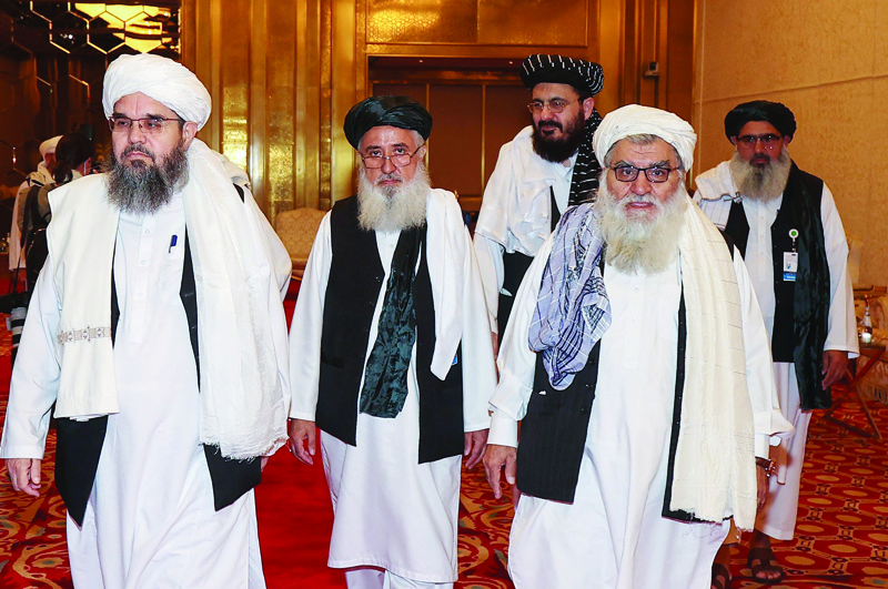 DOHA: A delegation of Afghanistan's Taleban movement attends a session of peace talks between the Afghan government and the Taleban yesterday. - AFP n