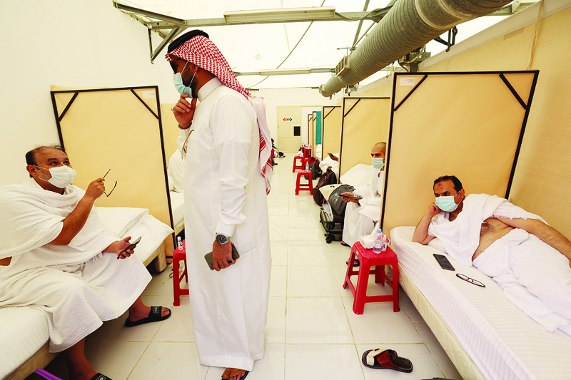MINA: Pilgrims rest at their camp in Mina near the holy city of Makkah yesterday. - AFP  n