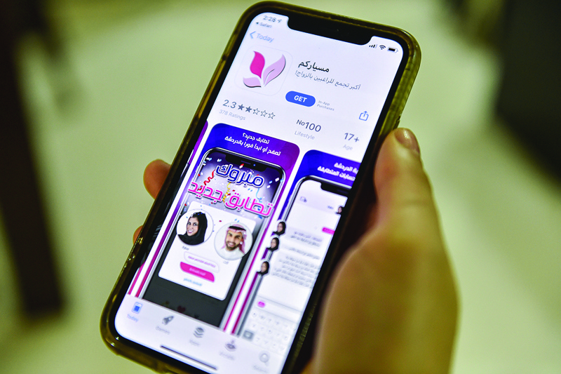 RIYADH: A woman holds a smartphone showing on its app store an app for facilitating misyar marriages on Oct 29, 2020. - AFP n