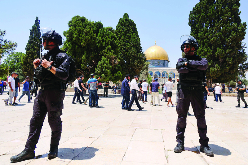 JERUSALEM: Members of the Zionist security forces stand guard as a group of Orthodox Jews enters the Al-Aqsa mosque compound yesterday. - AFP n