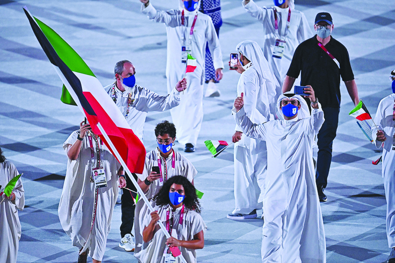 TOKYO: Kuwait's flagbearer Lara Dashti leads the Kuwaiti delegation during the opening ceremony of the Tokyo 2020 Olympic Games at the Olympic Stadium on Friday. - AFP n