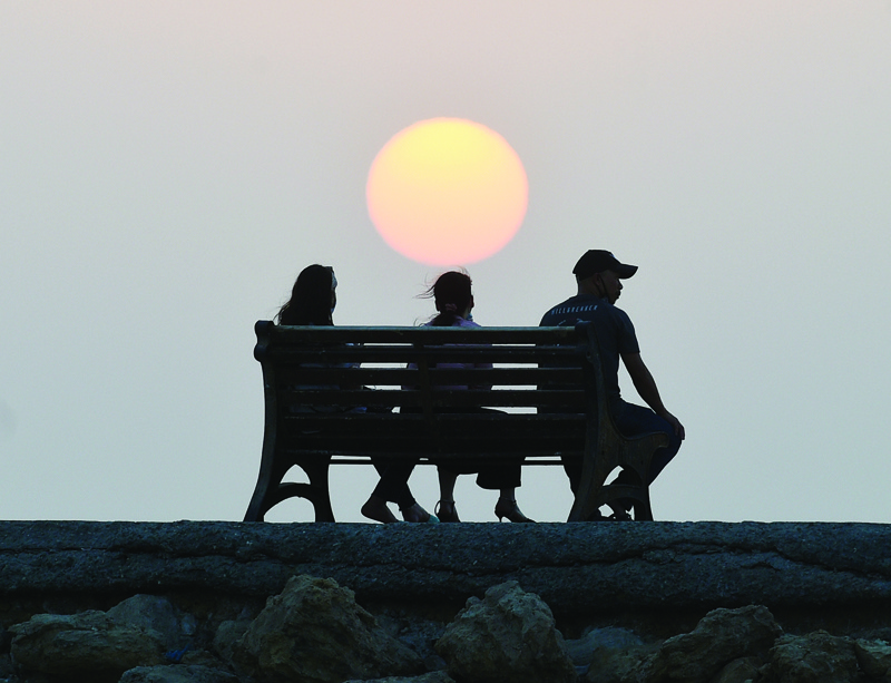 KUWAIT: People watch the sunset at a beach on July 24, 2021. - Xinhua n