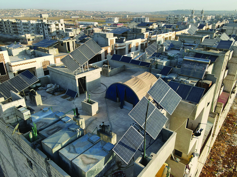 DANA, Syria: This aerial view shows solar panels on the rooftops of buildings in this town east of the Turkish-Syrian border in the northwestern Idlib province on June 10, 2021. - AFPn