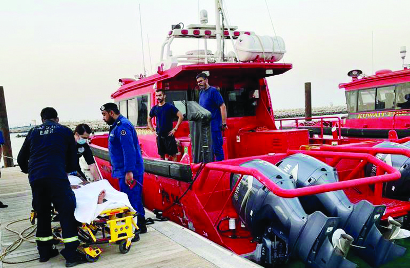KUWAIT: Paramedics attend to the man after firemen rescued him off the Salmiya beach yesterday.n