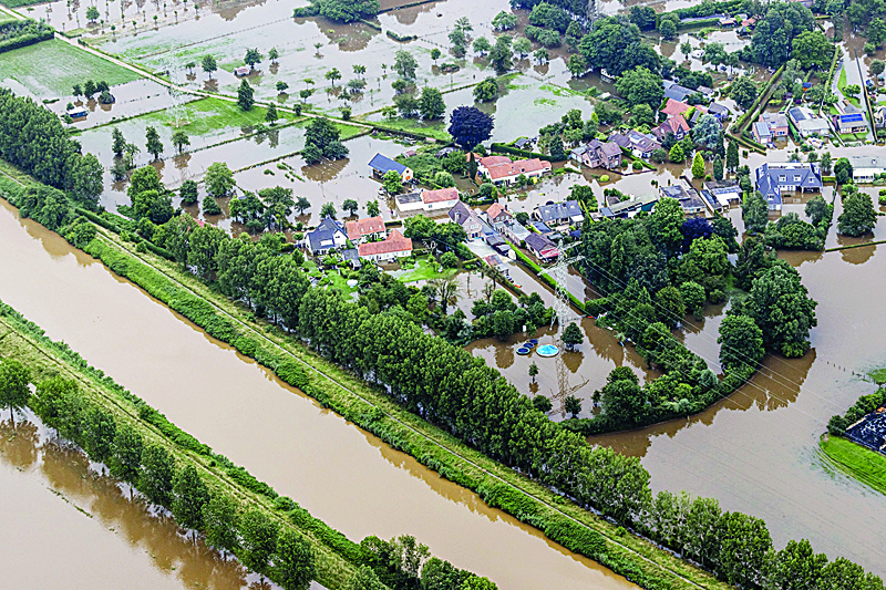 VALKENBURG: This aerial view taken in Brommelen, Netherlands on Friday shows the flooded area around the Meuse after a levee of the Juliana Canal broke. - AFPnn