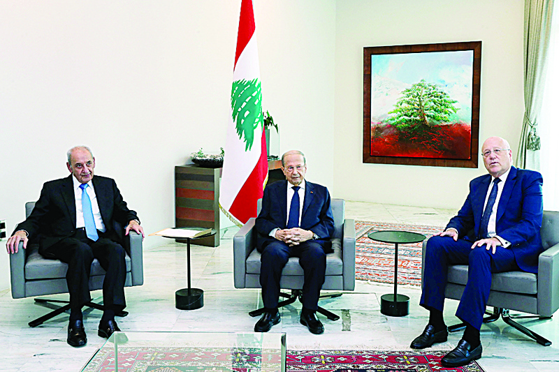 BAABDA: A handout picture provided by the Lebanese photo agency Dalati and Nohra shows Lebanon's Parliament Speaker Nabih Berri (L) and President Michel Aoun (C) meeting with two-time premier Najib Mikati at the presidential palace in Baabda, east of the capital Beirut yesterday. - AFPn