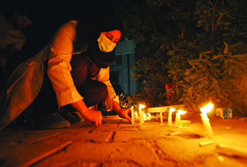 NASIRIYAH: People light up candles for a vigil in mourning for the victims of a fire that swept through a COVID-19 coronavirus isolation unit killing over 60 people and wounding dozens more, at al-Hussein Hospital in Iraq's southern city of Nasiriyah. - AFPnnnn