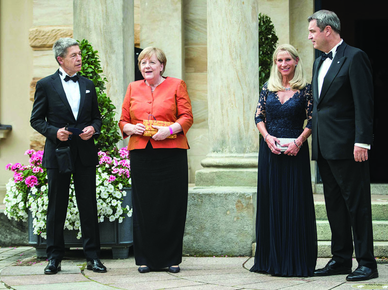 German Chancellor Angela Merkel, her husband Joachim Sauer, Bavaria's State Premier Markus Soeder and his wife Karin Soeder, arrive for the opening ceremony of the annual Bayreuth Festival featuring the music of German composer Richard Wagner on Sunday at the festival theatre (Richard-Wagner-Festspielhaus) in Bayreuth, southern Germany. – AFP n