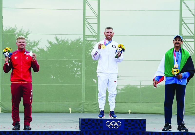 TOKYO: USA's gold medalist Vincent Hancock (center), Denmark's silver medalist Jesper Hansen (left), and Kuwait's bronze medalist Abdullah Al-Rashidi pose on the podium after the men's skeet final during the Tokyo 2020 Olympic Games at the Asaka Shooting Range in the Nerima district of Tokyo yesterday. - AFPn