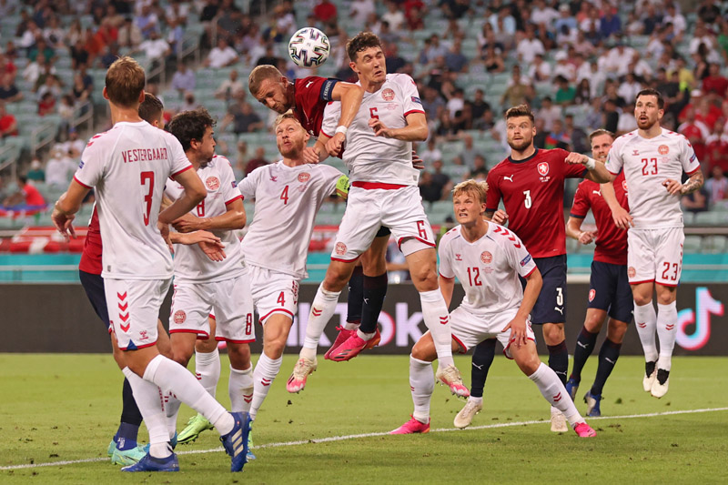 BAKU: Czech Republic's midfielder Tomas Soucek heads the ball as Denmark's defender Andreas Christensen defends during the UEFA Euro 2020 quarterfinal match at the Olympic Stadium yesterday. - AFP n