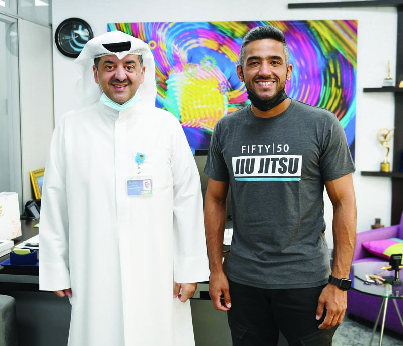KUWAIT: Zain's Waleed Al-Khashti with Kuwaiti MMA professional competitor Ahmad Al-Busairi.n