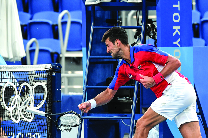 TOKYO: Serbia's Novak Djokovic smashes his racket during his Tokyo 2020 Olympic Games men's singles tennis match for the bronze medal against Spain's Pablo Carreno Busta at the Ariake Tennis Park in Tokyo yesterday. – AFPn