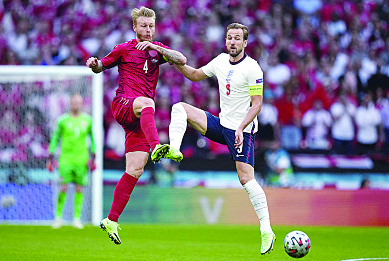 LONDON: Denmark's defender Simon Kjaer (left) fights for the ball with England's forward Harry Kane during the UEFA Euro 2020 semifinal match at Wembley Stadium on Wednesday. - AFP n