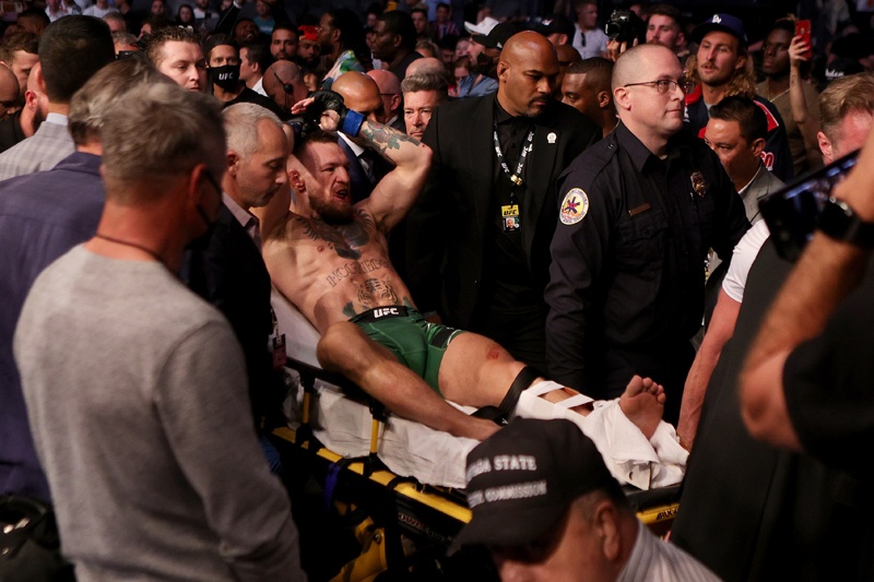 LAS VEGAS: Conor McGregor of Ireland is carried out of the arena on a stretcher after injuring his ankle in the first round of his lightweight bout against Dustin Poirier during UFC 264: Poirier v McGregor 3 at T-Mobile Arena on Saturday in Las Vegas, Nevada. – AFPn
