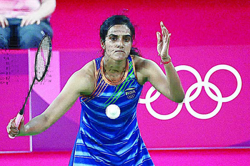 TOKYO: India's P V Sindhu hits a shot to Denmark's Mia Blichfeldt in their women's singles badminton round of 16 match during the Tokyo 2020 Olympic Games at the Musashino Forest Sports Plaza yesterday. - AFP n