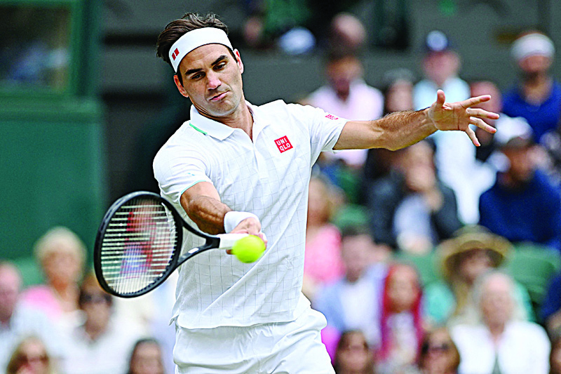LONDON: Switzerland's Roger Federer returns against Poland's Hubert Hurkacz during their men's quarter-finals match on the ninth day of the 2021 Wimbledon Championships at The All England Tennis Club on Wednesday. - AFP n