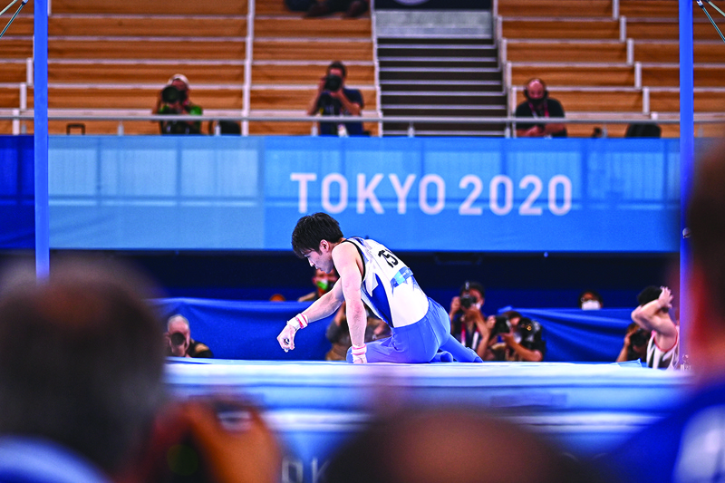 TOKYO: Japan's Kohei Uchimura reacts after competing in the horizontal bars event of the artistic gymnastics men's qualification during the Tokyo 2020 Olympic Games at the Ariake Gymnastics Centre in Tokyo yesterday. – AFPnn