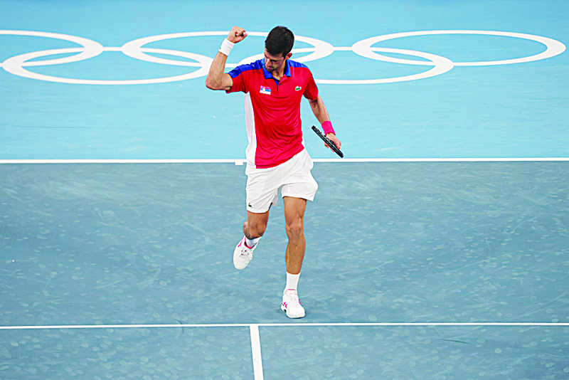 TOKYO: Serbia's Novak Djokovic celebrates after defeating Germany's Jan-Lennard Struff during their Tokyo 2020 Olympic Games men's singles second round tennis match at the Ariake Tennis Park in Tokyo yesterday. - AFPn