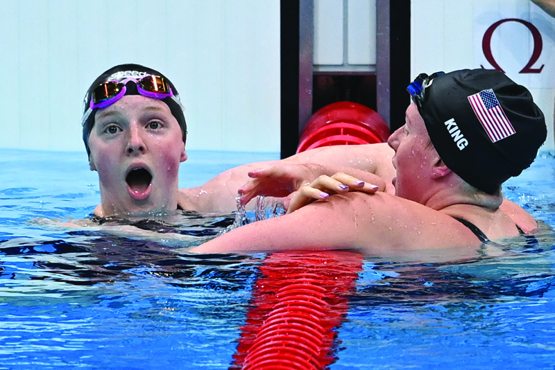 TOKYO: USA's Lydia Jacoby (left) celebrates winning with third-placed USA's Lilly King after the final of the women's 100m breaststroke swimming event during the Tokyo 2020 Olympic Games at the Tokyo Aquatics Centre in Tokyo yesterday. – AFPn