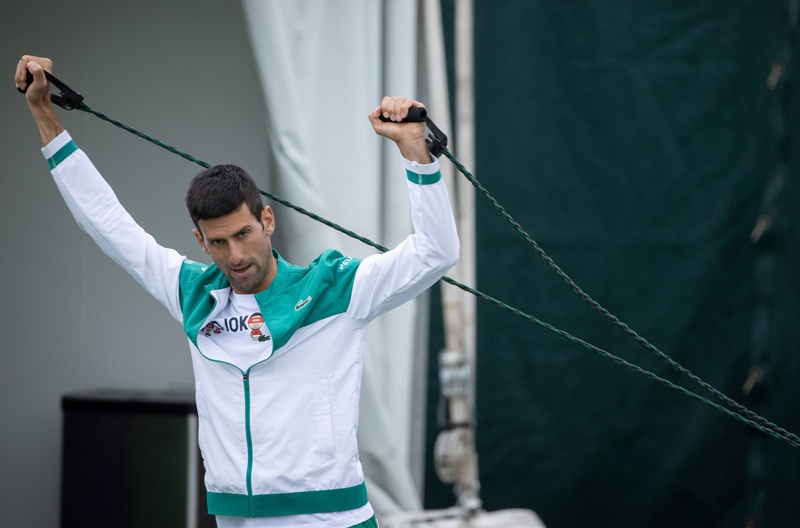 LONDON: Serbia's Novak Djokovic stretches at the Aorangi Practice Courts at The All England Tennis Club in Wimbledon, southwest London, yesterday. – AFPn