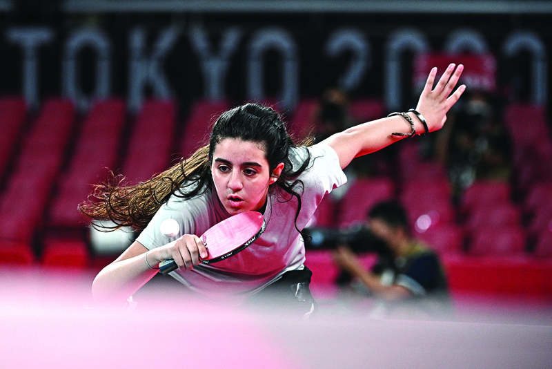 TOKYO: Syria's Hend Zaza hits a shot against Austria's Liu Jia during their women's singles preliminary round table tennis match at the Tokyo Metropolitan Gymnasium during the Tokyo 2020 Olympic Games in Tokyo yesterday.  - AFPn
