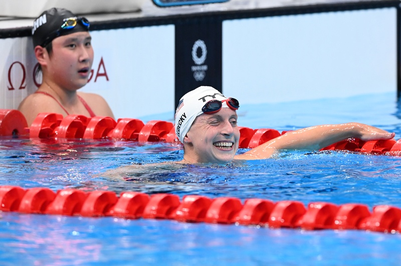 TOKYO: USA's Kathleen Ledecky (right) reacts after breaking the Olympic record next to second-placed China's Wang Jianjiahe after heat for the women's 1500m freestyle swimming event during the Tokyo 2020 Olympic Games at the Tokyo Aquatics Centre in Tokyo yesterday. – AFPnn