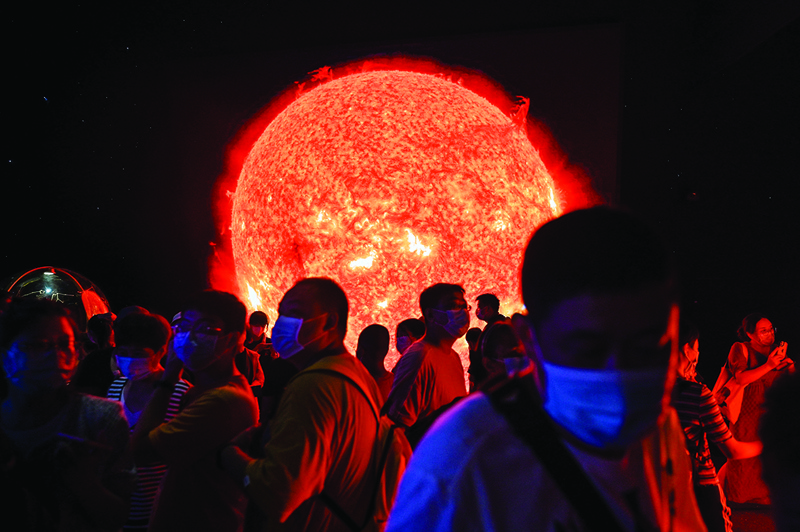 A depiction of the sun is seen as people visit the recently-opened Shanghai Planetarium in Shanghai. - AFP photosnnn