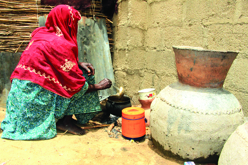 MAIDUGURI, Nigeria: In this file photograph taken on March 29, 2021, a woman cooks at Yawuri informal camp on the outskirts of Maiduguri, capital of Borno state. The makeshift camp hosts nearly 2,000 people internally displaced by a decade-long jihadist insurgency in northeast Nigeria. - AFPn