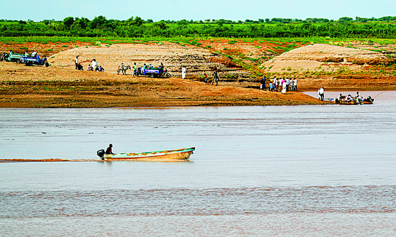 KASSALA, Sudan: A boat sails along the Setit river bordering Ethiopia, at Wad Al-Hiliou, a village in the eastern Sudanese state of Kassala. Tigrayan refugees who recover bodies washing up on the banks of the river, fear they are evidence of mass executions by government-allied troops in Tigray.-AFPn