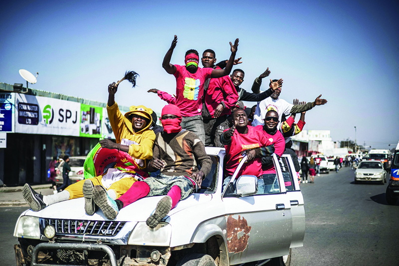 LUSAKA: Supporters of Zambian President elect for the opposition party United Party for National Development (UPND) Hakainde Hichilema gestures as they ride on a pick up truck in the streets of Lusaka yesterday. - AFPnn