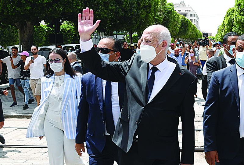 TUNIS: In this file handout picture provided by the Tunisian Presidency's official Facebook Page shows President Kais Saied (center) gesturing as he walks protected by security while touring through Habib Bourguiba avenue in the center of the capital Tunis. - AFPn