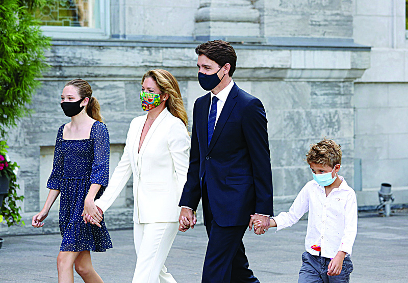 OTTAWA: Canada's Prime Minister Justin Trudeau (center), his wife Sophie Gregoire Trudeau (second left) and children Ella-Grace (left), and Hadrien arrive at Rideau Hall to ask Governor General Mary Simon to dissolve Parliament yesterday in Ottawa. - AFPnn