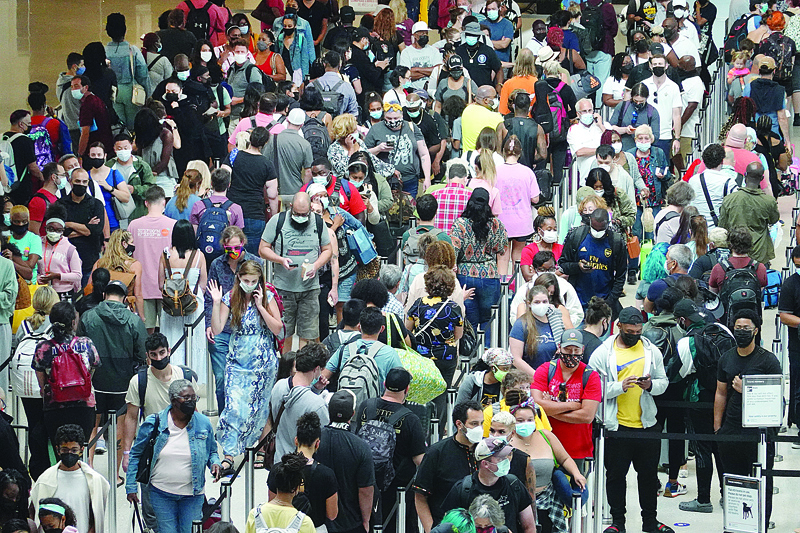 NEW ORLEANS, US: People stand in line to get through the TSA security checkpoint at Louis Armstrong New Orleans International Airport Saturday as they were evacuating the area as Hurricane Ida worked its way toward the Louisiana coastline in New Orleans, Louisiana. - AFPn
