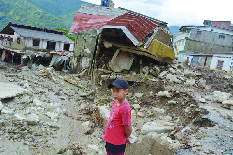 TOVAR MUNICIPALITY, Venezuela: A child stands in front of houses destroyed by a mudslide in the town of Tovar in the state of Merida.-AFP n