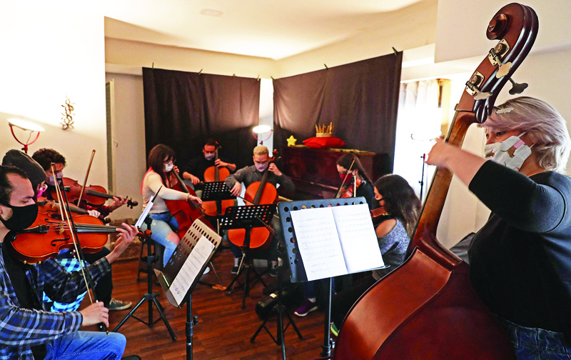 Venezuelan musicians, members of the Latin Vox Machine orchestra, perform “El Principito Symphonic” during a rehearsal at a house in Buenos Aires. — AFP photosn
