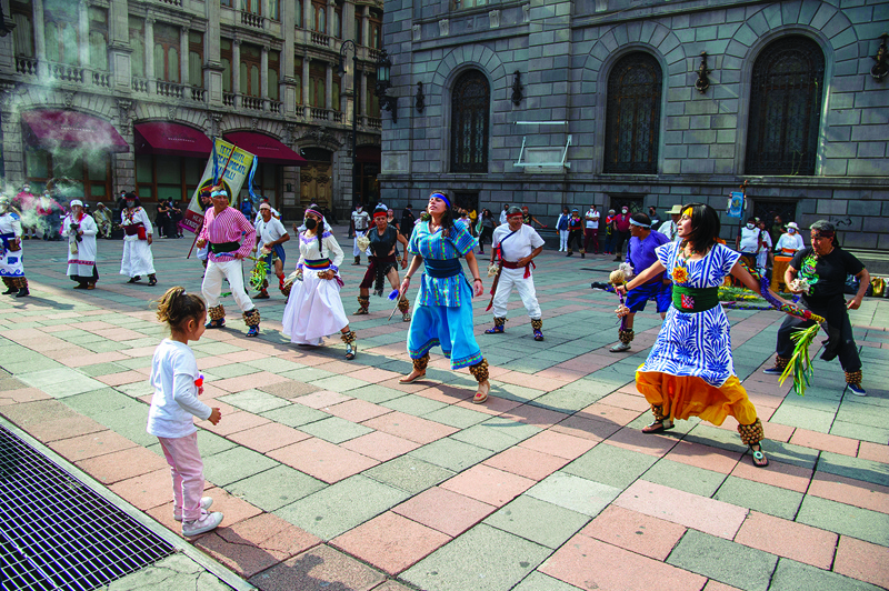 People perform an Aztec dance at the historical Center in Mexico City. — AFP photosn