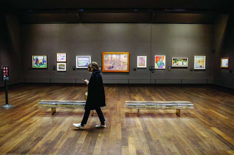 In this file photo a visitor walks past impressionist paintings in the under crowded Musee d'Orsay in Paris.—AFP n