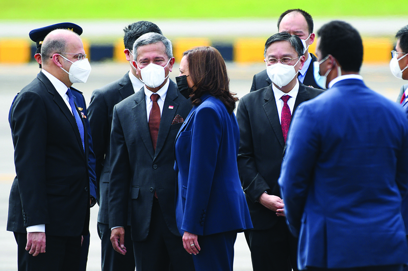 SINGAPORE: US Vice President Kamala Harris (center) is greeted by Singapore Foreign Minister Vivian Balakrishnan (left) and officials upon her arrival at Paya Lebar Base airport in Singapore yesterday.—AFPnn