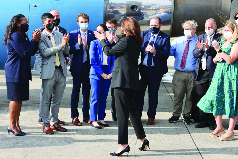 HANOI: US Vice President Kamala Harris (C) applauds staff as she departs Vietnam at Noi Bai International Airport, following her first official visit to Asia, in Hanoi yesterday.-AFPn