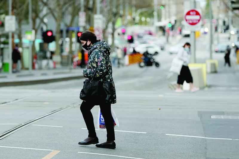 MELBOURNE, Australia: A woman walks along a street in downtown Melbourne yesterday as authorities there announced a sixth lockdown for the city in efforts to bring the Delta outbreak to heel. - AFPn