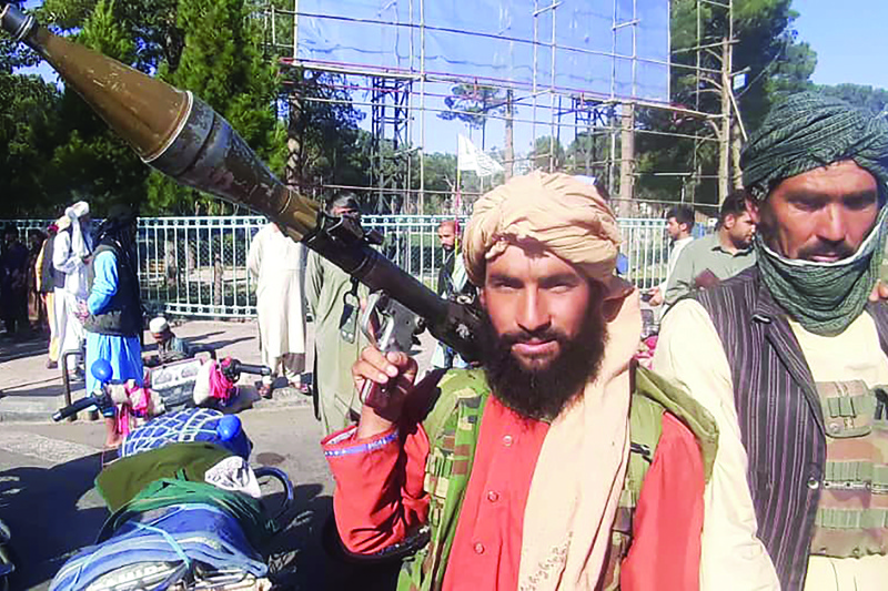 HERAT: A Taleban fighter holds a rocket-propelled grenade (RPG) along the roadside in Herat, Afghanistan's third biggest city, after government forces pulled out the day before following weeks of being under siege. - AFPn
