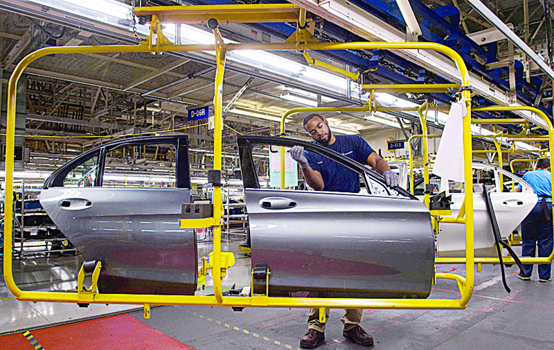 VANCE, United States: File photo shows an employee works on the doors for a Mercedes-Benz C-Class at the Mercedes-Benz US International factory in Vance, Alabama. American auto assembly lines continued working last month, pushing industrial production above analysts' expectations. - AFPnn