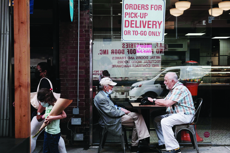 NEW YORK: People eat outside along a street in Manhattan in New York City. Despite continued concerns about the Delta variant of the COVID virus, the United States economy continues to grow with the leading economic index jumping 0.9% last month. - AFPn