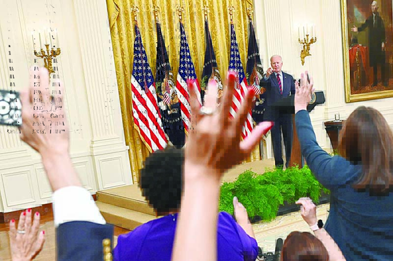WASHINGTON: Reporters raise their hands after US President Joe Biden speaks about COVID vaccinations in the East Room of the White House in Washington, DC, Tuesday. - AFPn