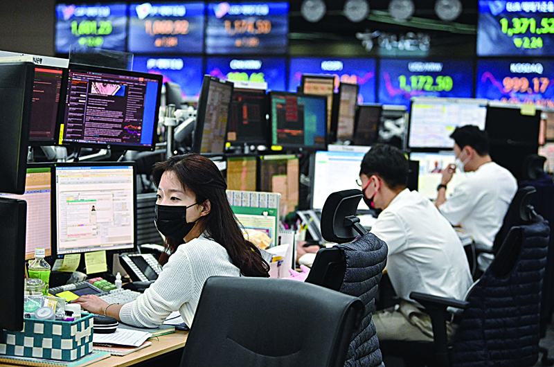 SEOUL: Currency dealers monitor exchange rates in a trading room at KEB Hana Bank in Seoul. - AFPn