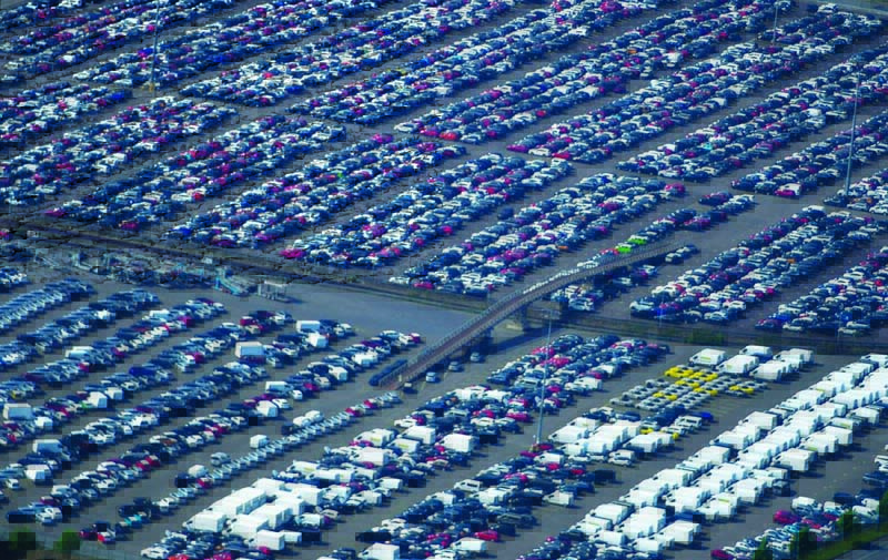 DUISBURG: An aerial view of new cars for sale at the harbor of Duisburg, western Germany. The German car market experienced a 25 percent drop in July 2021.-AFPn