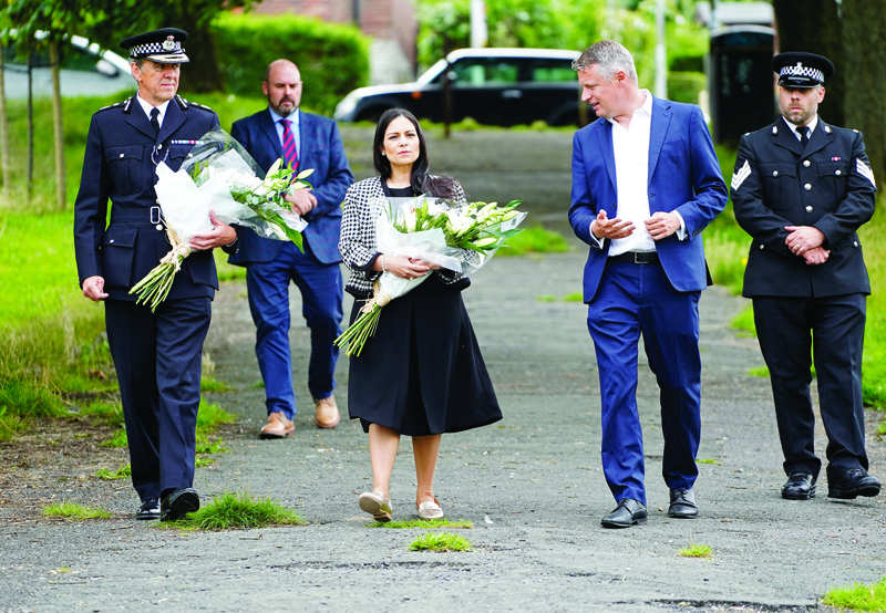 PLYMOUTH: Britain's Home Secretary Priti Patel (center) arrives with Chief Constable for Devon and Cornwall Police, Shaun Sawyer (left) and Labour MP for Plymouth, Sutton and Devonport, Luke Pollard (second right), to lay a floral tribute to the victims of the August 12 shootings in Plymouth, in North Down Crescent Park in the Keyham area, southwest England, yesterday. - AFPn